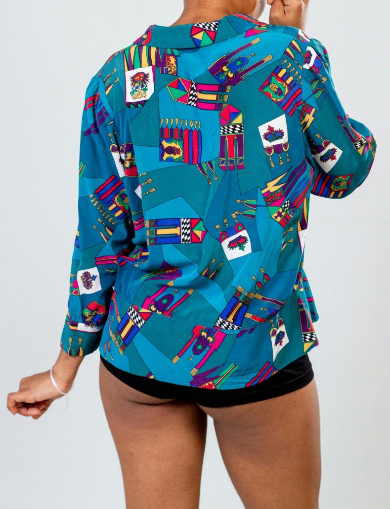 Back view of a person wearing a colorful patterned shirt and black shorts