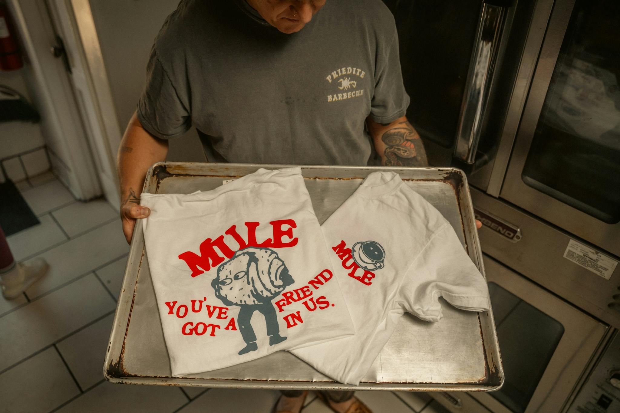 Person Showcasing White T Shirts With Red Mule